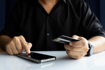 Online Payment with Credit Card on Laptop by Man in Black Shirt
