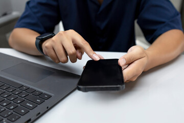 Person Using Smartphone with Laptop – Digital Communication and Technology Concept