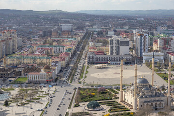 Aerial view of the city of Grozny in Chechnya. View of the city in the North Caucasus. Residential areas and the movement of cars through the streets of a big city.