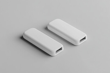 Fototapeta premium Two minimalist white usb chargers placed on a simple grey background for product presentation