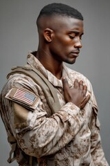 Military man salutes with pride during a solemn moment in uniform, showcasing dedication and honor on a neutral backdrop