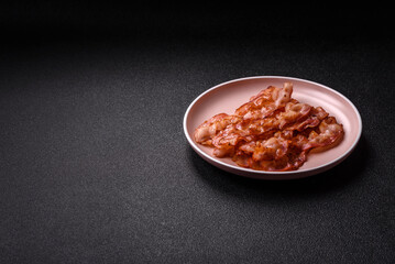 Cooked crispy bacon, slices of roast pork for an English breakfast. Fried bacon