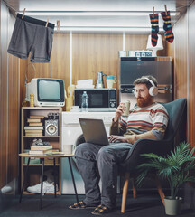 Man living in a stuffed one-room micro apartment