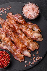 Cooked crispy bacon, slices of roast pork for an English breakfast. Fried bacon