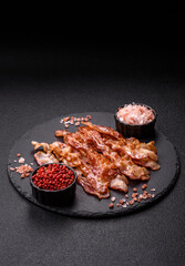 Cooked crispy bacon, slices of roast pork for an English breakfast. Fried bacon