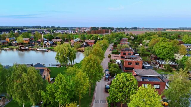 Green village with multiple canals. Drone flight over Vinkeveen, the Netherlands.