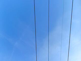 Obraz premium electricity post with blue sky background, power transmission line with blue sky