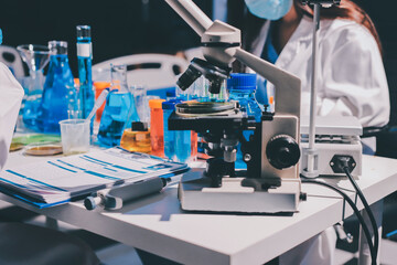 Scientist pipetting medical samples into microplate in laboratory