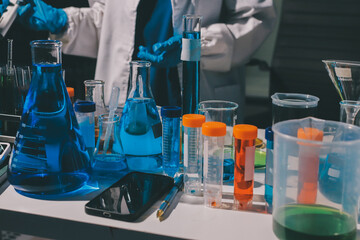 Scientist pipetting medical samples into microplate in laboratory