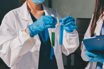 Scientist pipetting medical samples into microplate in laboratory