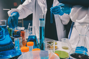 Scientist pipetting medical samples into microplate in laboratory