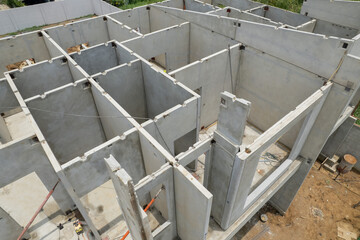 Construction of residential building with concrete walls underway in modern development site