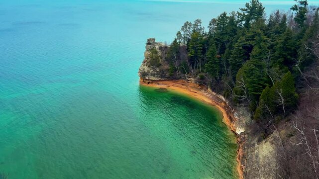 Miners Castle Rock at Pictured Rocks National Lakeshore Michigan during sunset with golden light over cliffs and Lake Superior.