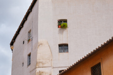 Flowers in a window on a side street in Rome, Italy
