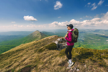 Obraz premium Young Woman with Backpack Traveling in Mountains