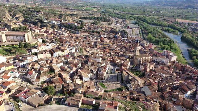 Scenic spring aerial view of El casco or Fraga la Vieja, old historic district of Spanish town of Fraga located on hilly Cinca river valley on sunny day. High quality 4k footage