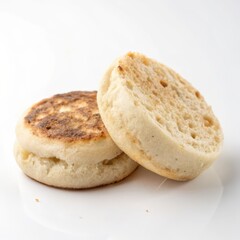 A freshly baked English muffin isolated on a white background, perfect for food-related projects and culinary themes.