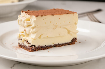 Elegant Tiramisu Cake Slice - Creamy Layered Dessert with Cocoa Dusting on White Plate for International Cake Day Celebrations and Dessert Photography