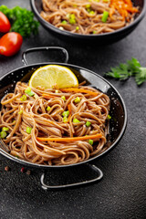 Buckwheat noodles soba bowl fresh dish Asian cuisine on the table rustic food top view copy space