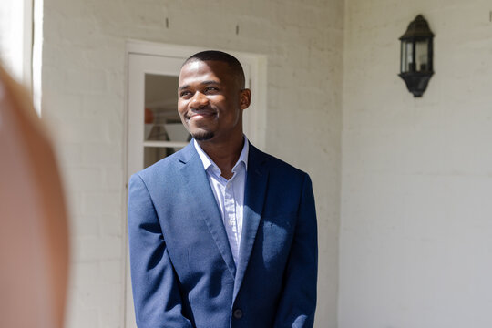 Smiling man in blue suit enjoying wedding celebration at elegant venue