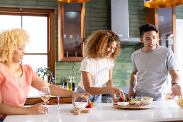 Preparing meal in modern kitchen, Diverse friends sharing conversation and laughter together