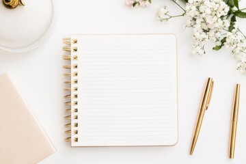 White Notepad with Gold Pens and Flowers on a Minimalist Desk