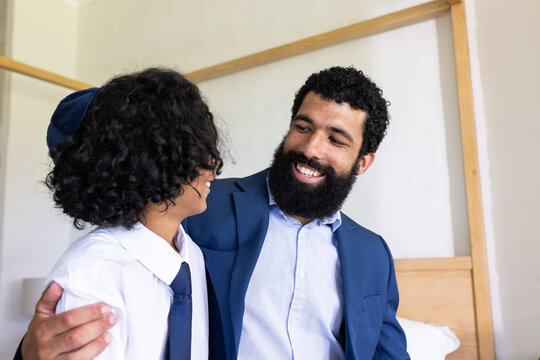 Diverse family, Father and son in formal attire smiling and bonding at home