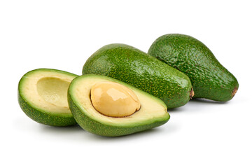 Fresh green avocados, whole and halved with kernel, isolated on white background.