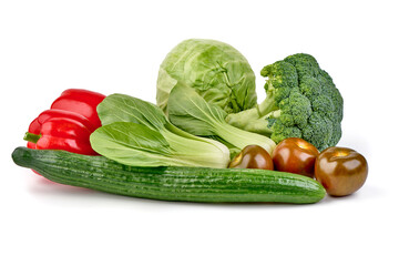 Assorted fresh vegetables: pak choi, cucumber, red bell peppers, Kumato tomatoes, cabbage and broccoli, isolated on white background.