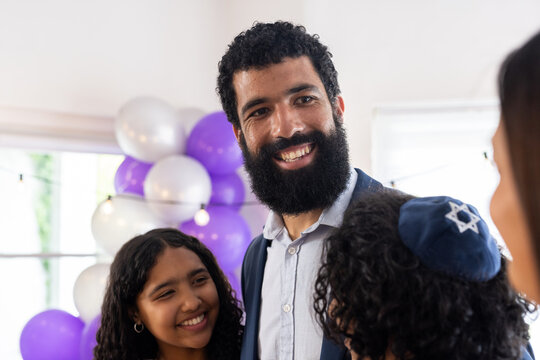 Celebrating religious event, diverse family with balloons, smiling together, at home