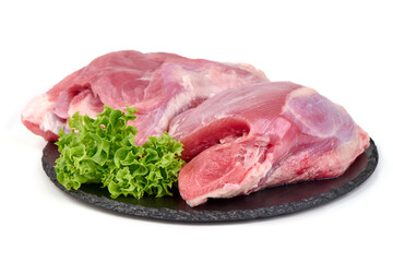 Raw rabbit hind legs with lettuce garnish, isolated on white background.