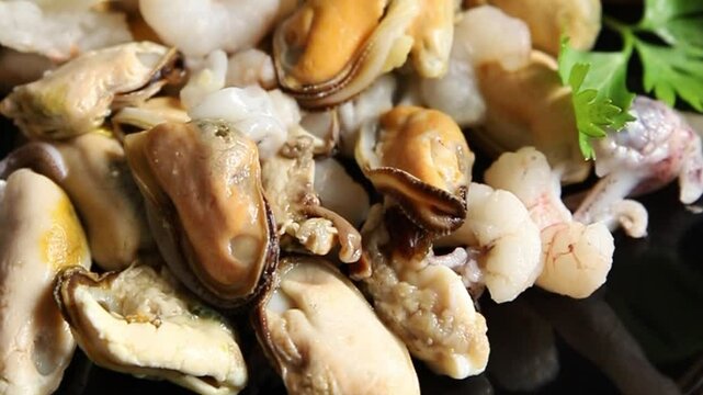 Seafood mix mussels, shrimp, prawn, rapan, squid dish fresh gourmet food background on the table rustic food top view copy space pescetarian diet