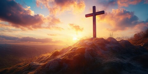 Sunrise view of a wooden cross on a hilltop with colorful clouds during dawn in a serene landscape