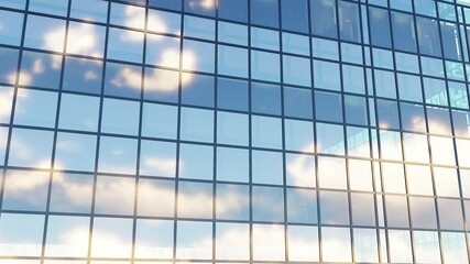 Skyscraper glass building close up. It's the video of reflection of blue sky and clouds in windows of skyscraper. It is close up view of glass window wall of building in midday. Modern architecture	