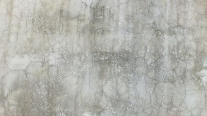 Rough grey concrete wall textured with detailed crack patterns, suitable for background and industrial themes.