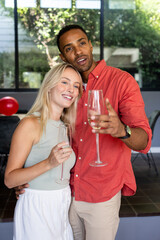 Celebrating with champagne glasses, couple smiling during festive moment at party