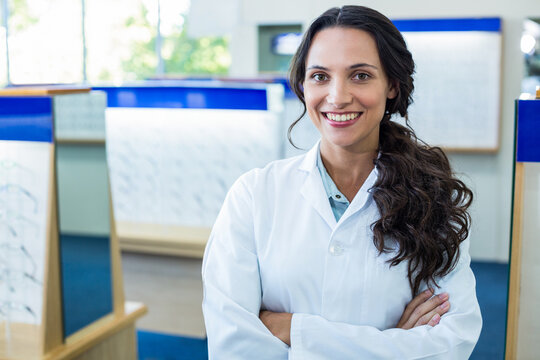 Wooden display stands are holding assorted eyeglass frames in bright showroom with large windows