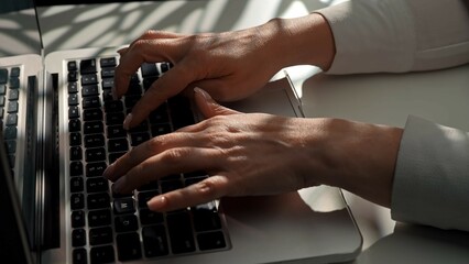 Hands Typing on a Laptop Keyboard in Natural Light