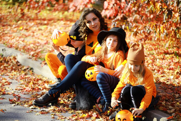 Happy family walk in the park on Halloween. Family dressed up in Halloween costumes
