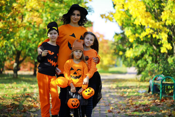 Happy family walk in the park on Halloween. Family dressed up in Halloween costumes