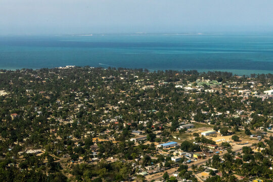 Aerial view over the coastal town of Vilanculos along the Mozambique coast against the bright blue waters of the Indian Ocean.