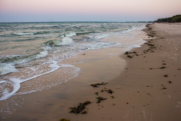 Small waves on the sandy beach at Inhassoro at dusk in Mozambique.