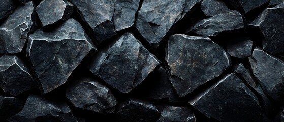 Striking monochrome image of a textured fractured stone surface with a raw industrial aesthetic