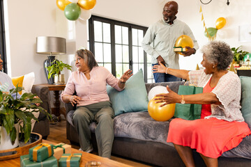 Family celebrating at home, exchanging gifts and enjoying joyful moments together