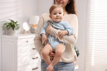Mother with her cute little baby at home, closeup