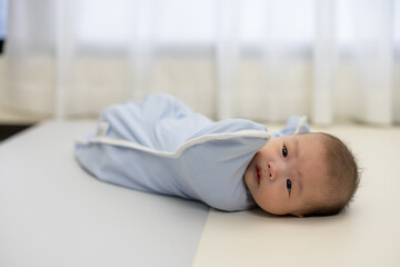 Sleeping baby in soft swaddle