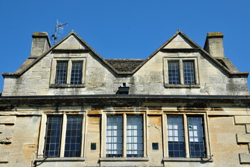 Exterior view of the upper floors of a beautiful old town house on a street in an English city