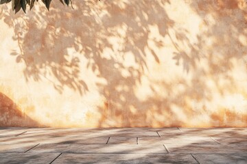 Beige wall, leaf shadows, outdoor space.  Gentle sunlight casts dappled patterns on a light beige stucco wall, with a paved ground plane