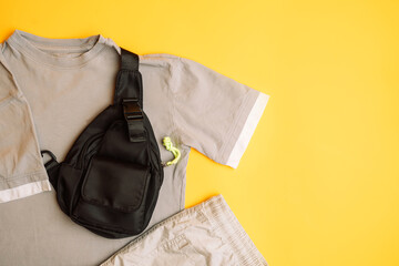 Stylish dark and light grey children's T-shirt with jeans and black bag. Fashion kids outfit for...