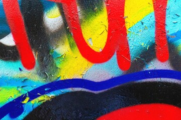 Bold abstract graffiti texture in red, blue, yellow with peeling paint. Urban street art, vibrant...